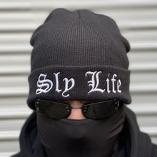 Load image into Gallery viewer, Sly Life Apparel beanie in black with white embroidered logo of the words “Sly Life” on the front cuff