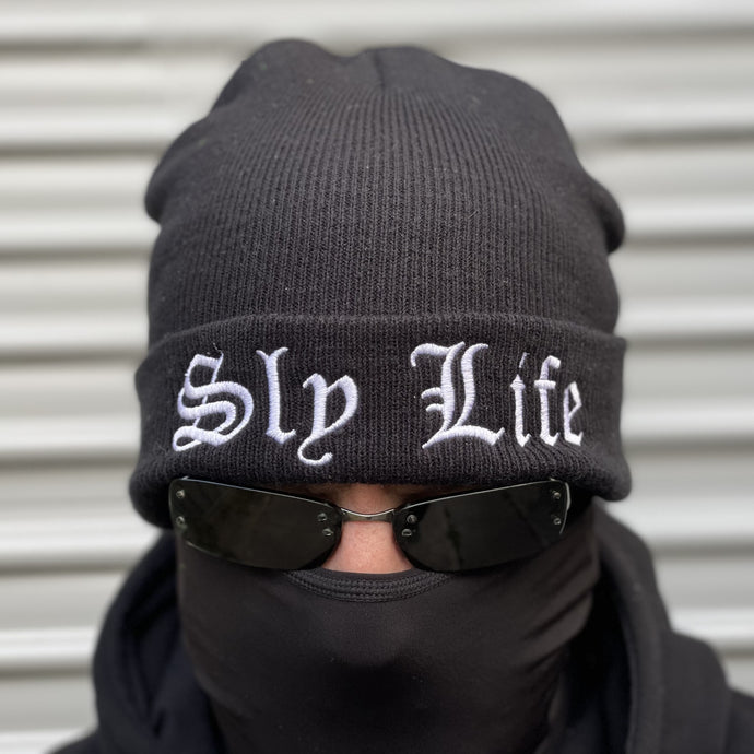 Sly Life Apparel beanie in black with white embroidered logo of the words “Sly Life” on the front cuff